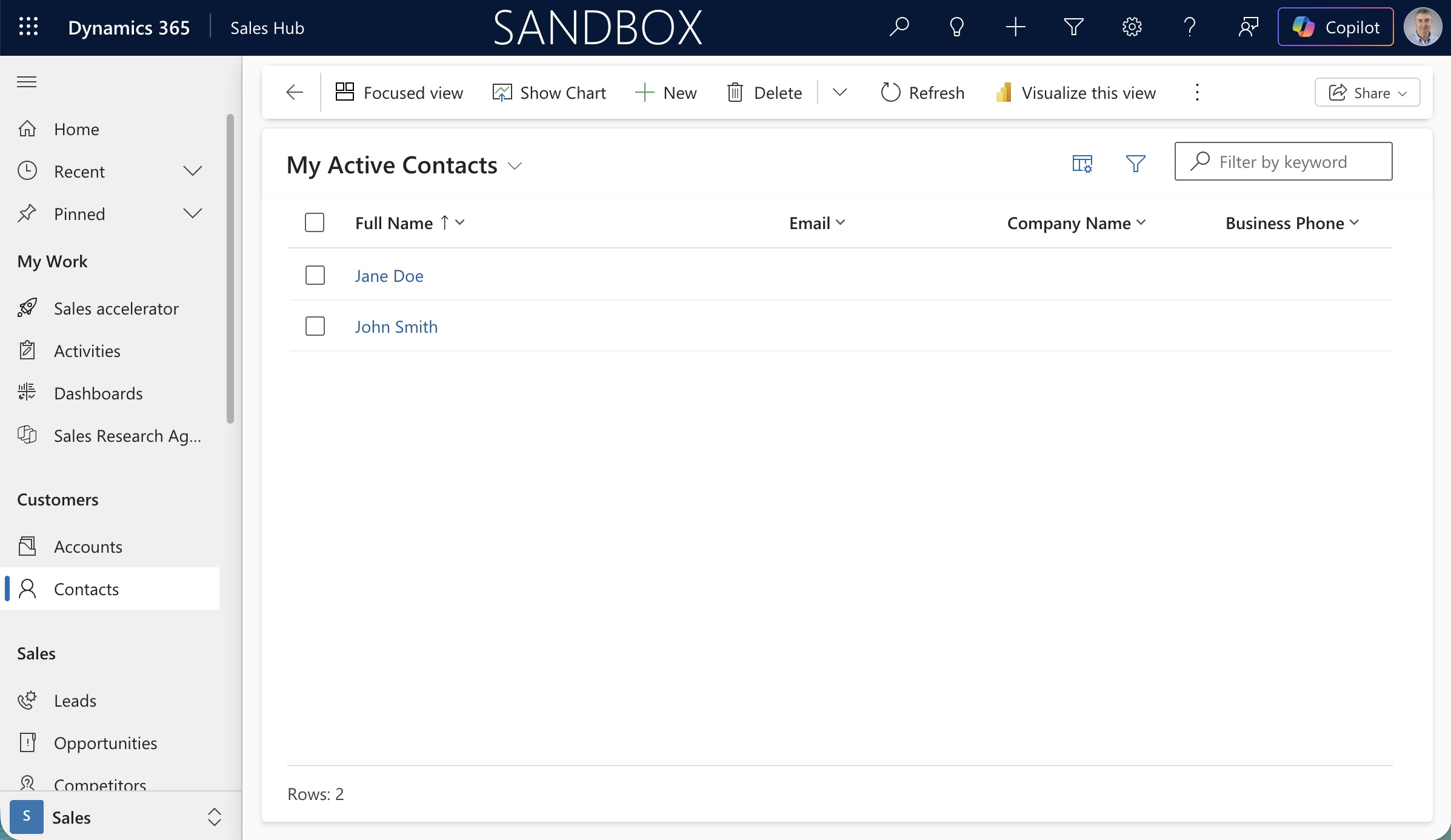 The Dynamics 365 Sandbox showing My Active Contacts with Jane Doe and John Smith