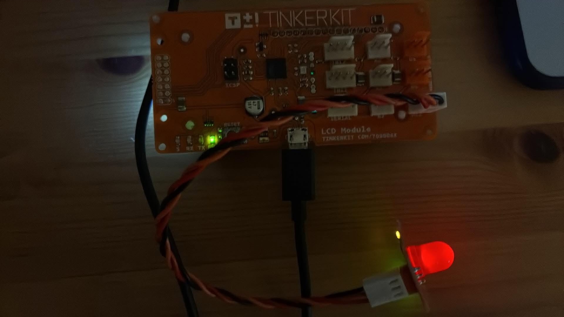 The red LED lit mid-flash on the rear connector, synced to the counter