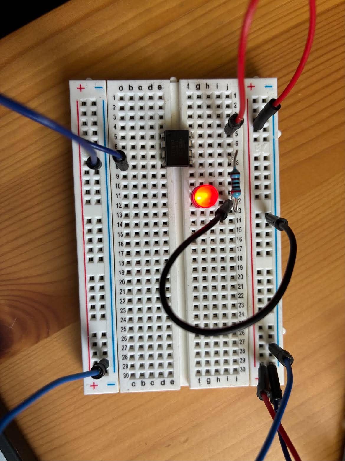 The breadboard LED lit on the ATtiny85 circuit. This is a single frame, so it shows that the output works, not the 500 ms timing.