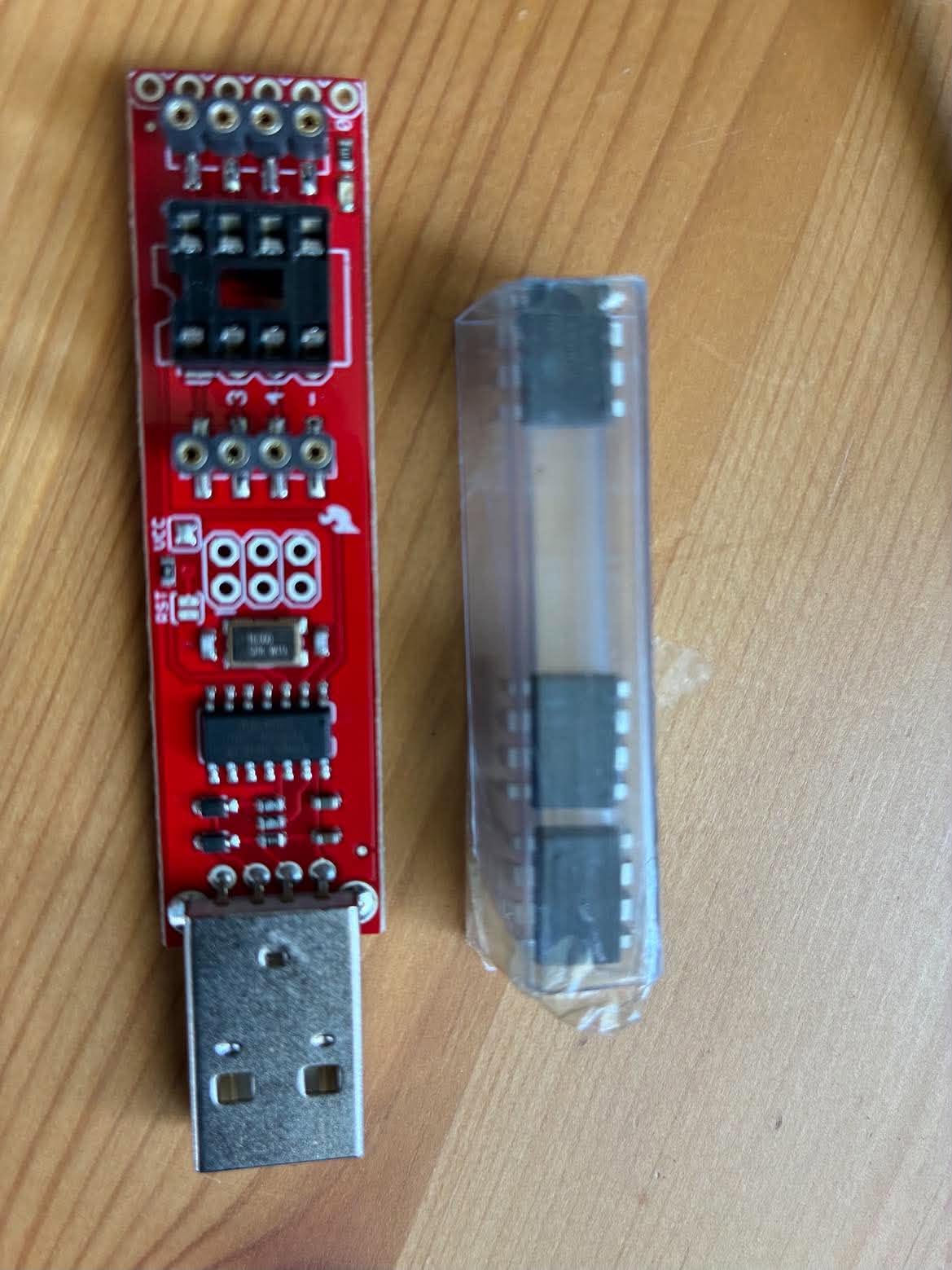 The Tiny AVR Programmer beside a tube of ATtiny85 chips