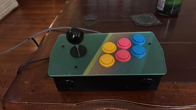 The completed Picade console with its green acrylic top panel, joystick, and coloured arcade buttons
